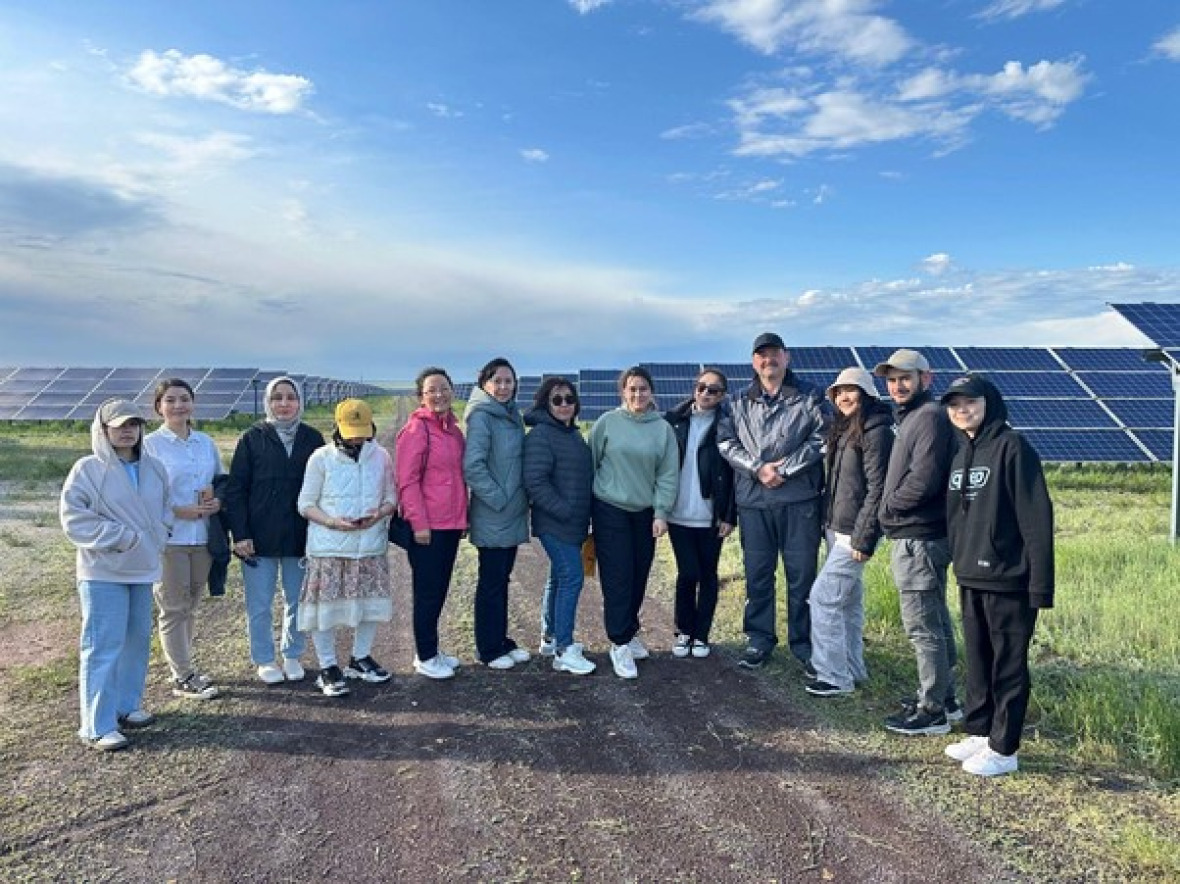 Participants in the German-Kazakh University's 2024 Renewable Energy Trip at a solar farm in Kazakhstan.